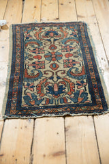 Corner of antique Persian Borchalou rug, curvilinear florals on ivory, dark blue border, tattered end.