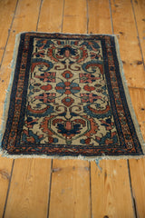 Antique Persian Borchalou rug corner, showing floral scrollwork, worn fringe, and side tatter.