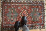 Vintage Heriz area Karaja rug, circa 1920s, with low pile and tattered fringes.