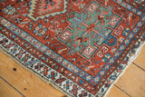 Karaja rug corner detail, featuring geometric motifs, brick red field, and end tatter.
