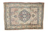 Antique Persian Kerman square rug with a roundel medallion in navy blue, mauve, and ivory.