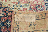 Rare handwritten provenance tag on the hand-knotted foundation of an antique Persian Kerman rug.