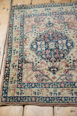 Detailed corner of a Collector Persian Kerman rug with indigo blue and mauve floral vinery.