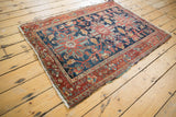 Intricate curvilinear vinery and palmettes on vintage Heriz rug, showing even wear.