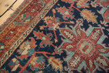 Vintage Heriz rug pattern displaying intricate vinery and palmettos in navy, red, and teal.