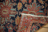 Secured fringed end of vintage Heriz rug, revealing hand-knotted pile and even wear.