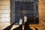 Antique Belouch rug right side: geometric ivory border, tone-on-tone indigo, charcoal patterns.