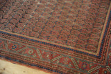 Antique Malayer carpet detail: repeating boteh motif, geometric border, mostly even wear.