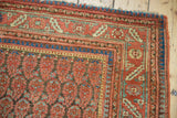 Antique Malayer rug corner detail with boteh field, traditional borders, blush, indigo, and seafoam tones.