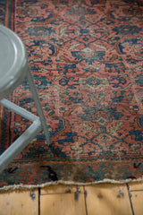 Lower edge of a vintage Lilihan rug, displaying worn dusty dark rose and blue Herati patterns.