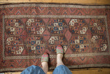 Vintage Belouch runner with oversized gul motifs, intricate fills, madder red, and sky blue.