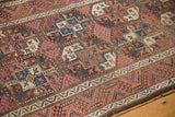 Vintage Belouch runner's intricate gul motif, diamond fills, madder red, brown, and visible pile wear.