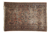 Vintage Lilihan rug with shadow medallion, scrolling vinery, dusty blush, navy, and ivory colors.