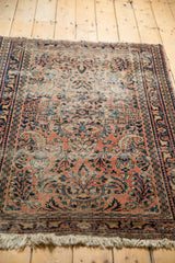 Dusty blush red Lilihan rug field, faded blue floral motifs, and visible worn knot heads.