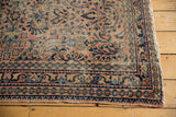 Vintage Lilihan rug corner showcasing intricate floral border, geometric band, and end wear.