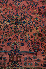 Detail of vintage Mohajeran Sarouk rug with raspberry field, blue-green floral sprays, and mellowed tones.