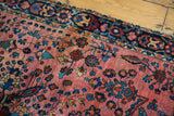Vintage Mohajeran Sarouk rug detail: dusty raspberry field, teal florals, and dark blue border.