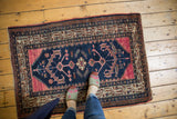 Hand-knotted vintage Hamadan rug with raspberry red and navy blue motifs underfoot.