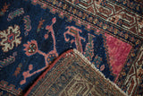 Vintage Hamadan rug corner, showing low pile, secure selvage, and hand-knotted foundation.