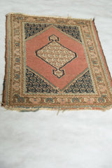 Tattered end with loss and detailed floral border of the 1940s vintage Tabriz rug.