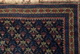 Detail of the early 20th century Belouch rug's unusual germinating flower motif.