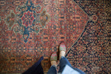 Antique Farahan Sarouk carpet with intricate terra cotta field, navy border, and medallion detail.