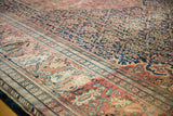 Antique Persian Farahan Sarouk carpet: navy blue henna field, terra cotta palmette border detail.