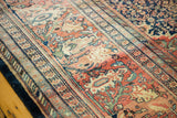 Stately Persian Farahan Sarouk borders with time-softened navy, terra cotta, and mallard green tones.