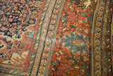 Antique Farahan Sarouk rug showing intricate borders and a detailed floral vine field.