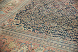 Antique Farahan Sarouk rug detail: navy blue floral field, terra cotta palmette border.
