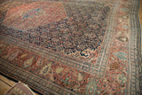 Antique Farahan Sarouk corner with traditional Persian curvilinear design.