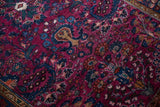 Vintage Lilihan rug detail: low pile, visible knot heads, and dark raspberry floral design.