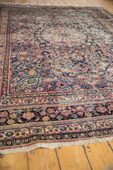 Vintage Meshed carpet's intricate floral border and fringe, with blush red and cobalt blue tones.