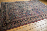 Vintage Meshed carpet's lower right showing floral field with palmettes and ornate border.