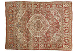 Vintage Tabriz rug with serrated concentric medallions in dark terra cotta rust, sand, and powder blue.