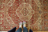 The low pile and dramatic serrated medallions of a vintage Tabriz rug in rust and sand tones.