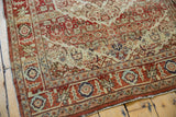 Detail of the vintage Tabriz rug's low pile, rust border, and serrated medallion in sand.