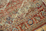 Detail of the vintage Persian Tabriz rug's corner, showing the terra cotta rust border and low knot heads.