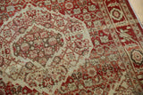 Low pile texture and serrated medallion details on a vintage Tabriz rug in terra cotta and beige.