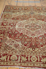 Intricate serrated medallions and low-pile texture on a vintage hand-knotted Tabriz rug.