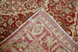 Back of vintage Tabriz rug showing hand-knotted construction and professionally secured side binding.