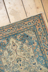 Patina on dusty teal and rose borders of antique Haji Jalili Tabriz rug with ivory field.