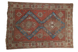 Antique Caucasian rug, brick red field, aqua blue geometric double medallion, ivory details.
