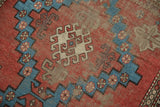 Antique Caucasian rug: geometric brick red, aqua blue, ivory patterns, and mostly even wear.