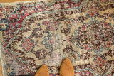 Vintage Kerman runner, traditional Rococo floral field in antique ivory, red, and blue with worn pile.