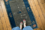 Worn slate blue gray field, cobalt blue border, and floral details of an antique Peking rug.