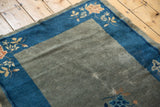 Antique Chinese Peking rug corner, blue border, traditional peach floral, worn gray-green field.