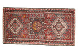 Hand-knotted vintage Karaja rug with cherry red field, geometric medallions, and varied motifs.