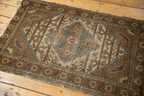 Vintage Sparta rug corner with mahi-style motifs, agricultural patterns, and visible wear.