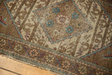 Vintage Sparta rug corner with Mahi motifs, agricultural patterns, worn edges in blue, sand, and blush tones.